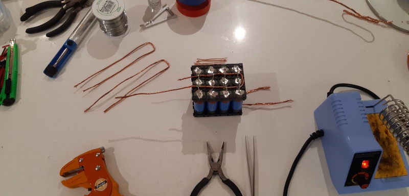 Soldering bus bars and fuses onto each cell